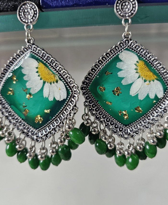 Green resin earrings with pressed daisies and green bead accents