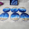 Unique beach-inspired wooden coasters with resin waves and sand