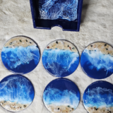 Handmade wooden resin coasters with ocean wave design.