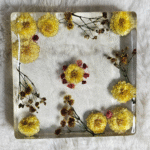 Square resin paper weight with dried yellow and pink flowers