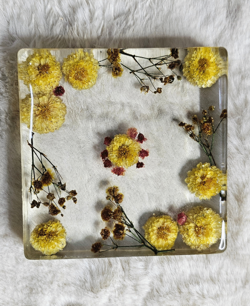 Square resin paper weight with dried yellow and pink flowers