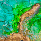 Unique round resin art in emerald green and gold accents