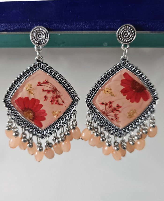 Peach resin earrings with red flowers and gold leaf accents
