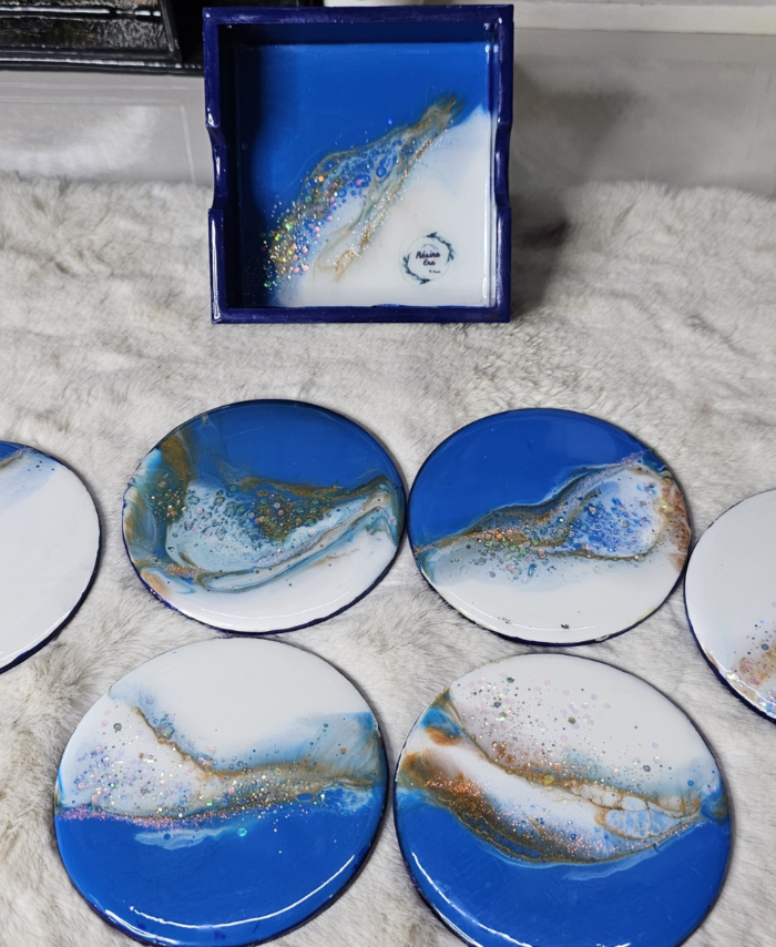 Galaxy-themed resin coasters with blue hues and glittering finish