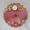Handmade pink pooja thali with floral decorations