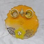 Handmade yellow pooja thali with Ganesha design and floral work