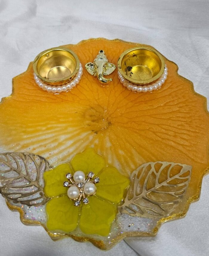 Handmade yellow pooja thali with Ganesha design and floral work