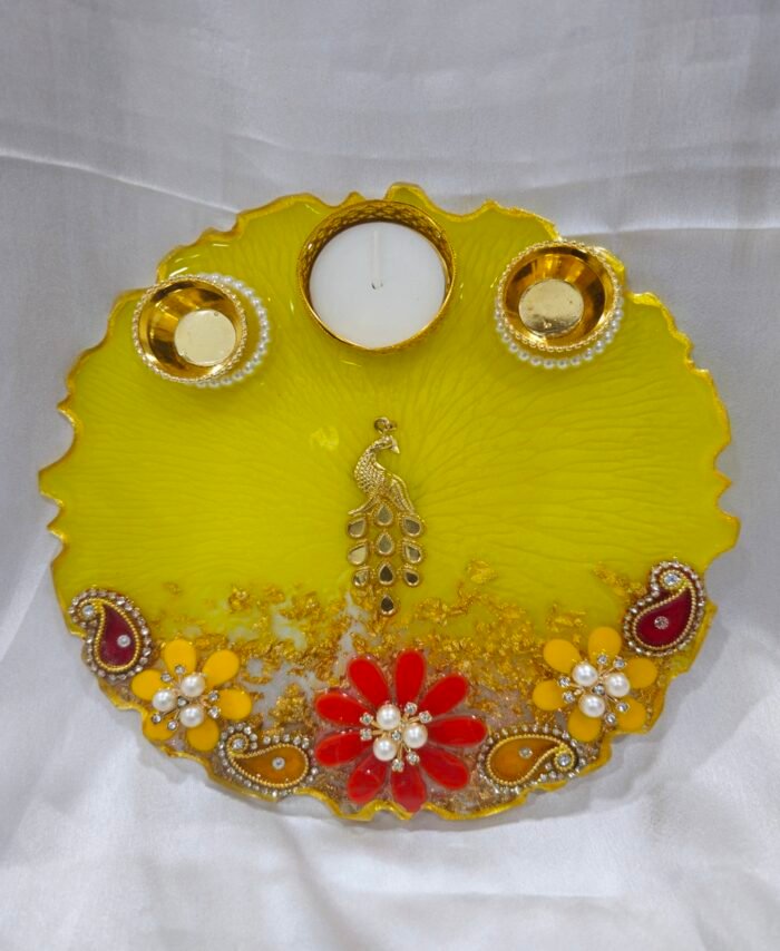 Pink Resin Diya Thali with Ganesha Idol and diya holders.