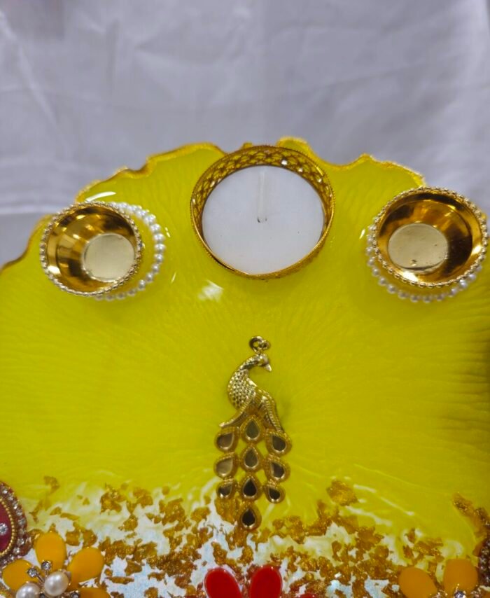 Elegant Ganesha Poja Thali with floral and pearl design.