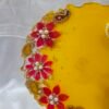 Handmade Diya Thali with vibrant floral design and pearls.