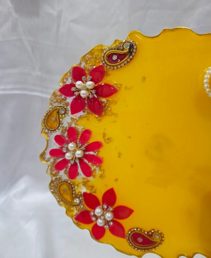 Handmade Diya Thali with vibrant floral design and pearls.