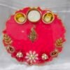 Pink pooja thali with golden peacock and pearl diya holders