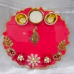 Pink pooja thali with golden peacock and pearl diya holders