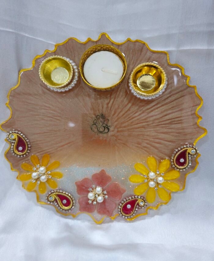 Beige floral pooja thali with yellow and pink decorations