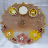 Beige floral pooja thali with yellow and pink decorations