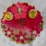 Peach resin pooja thali with paisley and floral design