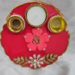 Maroon resin pooja thali with Ganesh idol and shloka