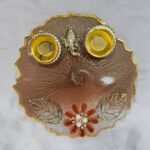 Brown resin pooja thali with Ganesha idol and diya holders