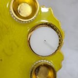 Bright yellow resin thali with golden embellishments