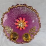 Purple resin pooja thali with floral centerpiece