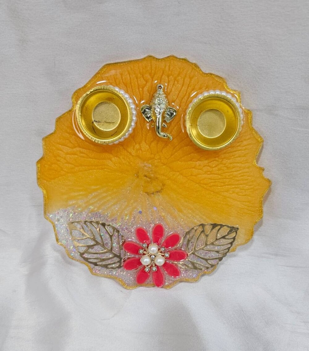 Orange resin pooja thali with Ganesha and diya holders