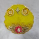 Yellow resin pooja thali with Ganesha idol