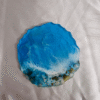 Resin coaster featuring deep blue and white wave patterns