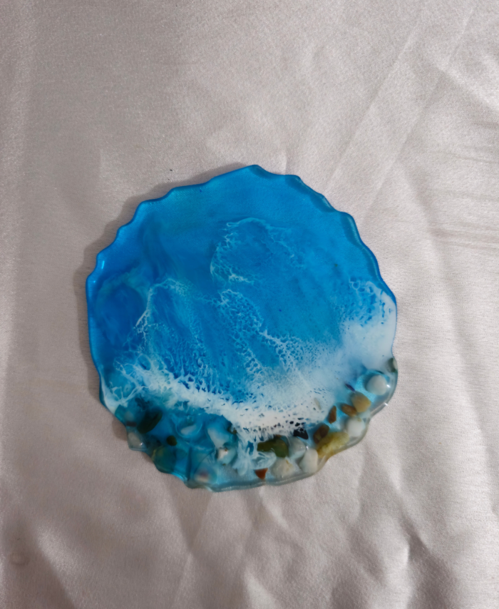 Resin coaster featuring deep blue and white wave patterns