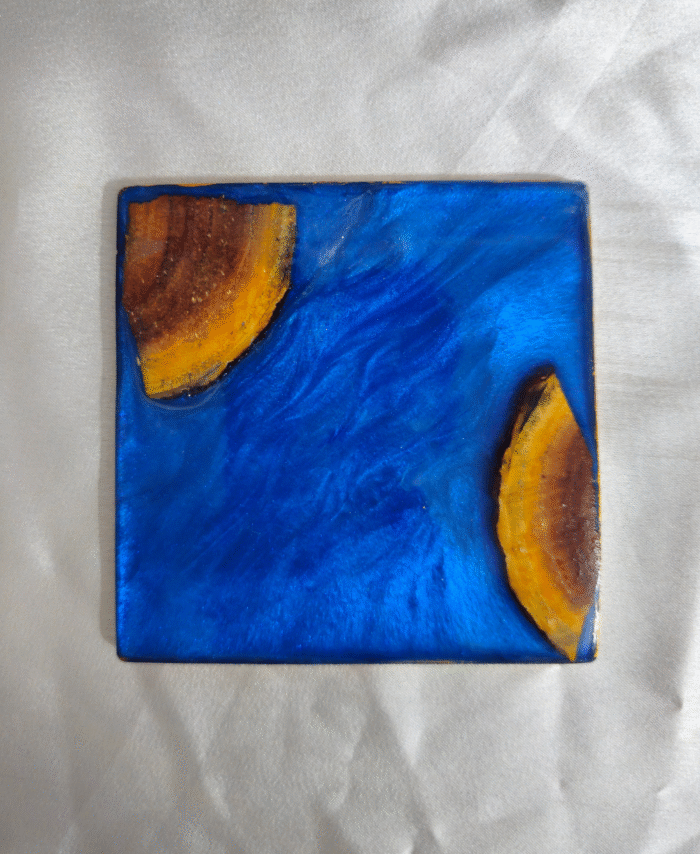 Handmade square blue resin and wood coaster with ocean-inspired design by Resineera