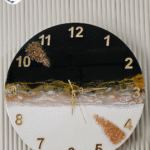 Handmade black and gold geode resin wall clock with metallic accents and quartz-like texture