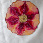 Handcrafted red and gold flower-shaped resin coaster with crystal embellishments