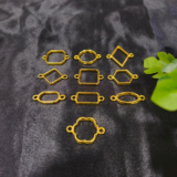 Golden assorted double-side hooks in mixed shapes displayed on black background – resin jewellery base set.