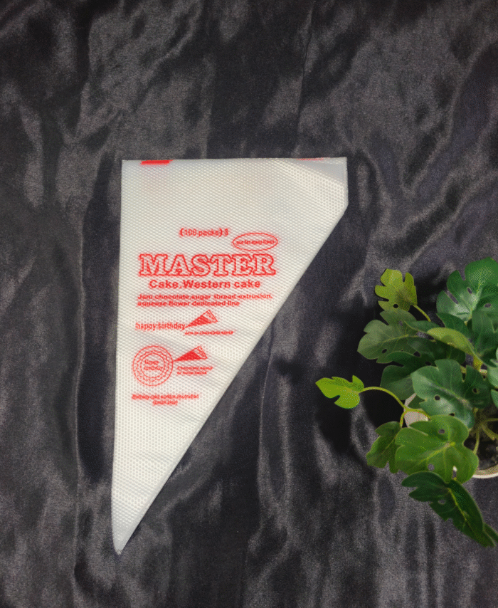 White disposable piping bag with red print placed on dark background.
