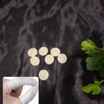 Latex finger protectors arranged on a black background for resin and craft use. Close-up of a hand wearing latex finger protectors for safe and clean crafting.