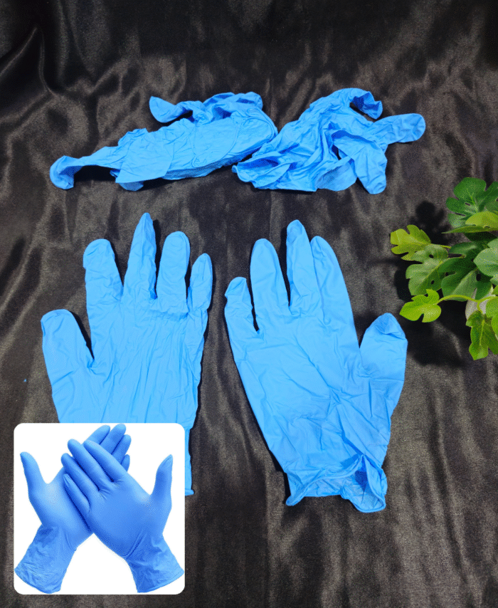 Blue nitrile disposable gloves arranged on a black surface with a pair of gloves shown worn on hands.”