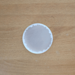 3-inch round agate silicone mould with wavy edge placed on a wooden surface
