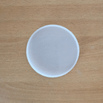 4-inch round silicone mould for resin casting placed on a wooden surface.