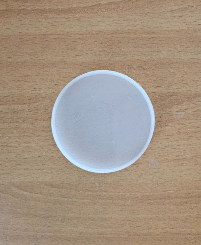 4-inch round silicone mould for resin casting placed on a wooden surface.