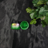 Leaf Green 03 opaque resin pigment jar opened and displayed on a black background