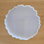 10-inch white silicone agate mould with irregular geode-style edges on a wooden background Large round agate resin mould used for creating geode-inspired resin art