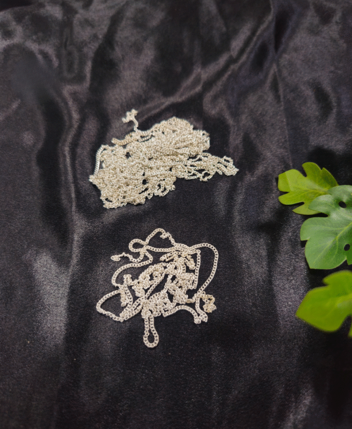 Silver metal jewellery chain for DIY and crafting displayed on black fabric