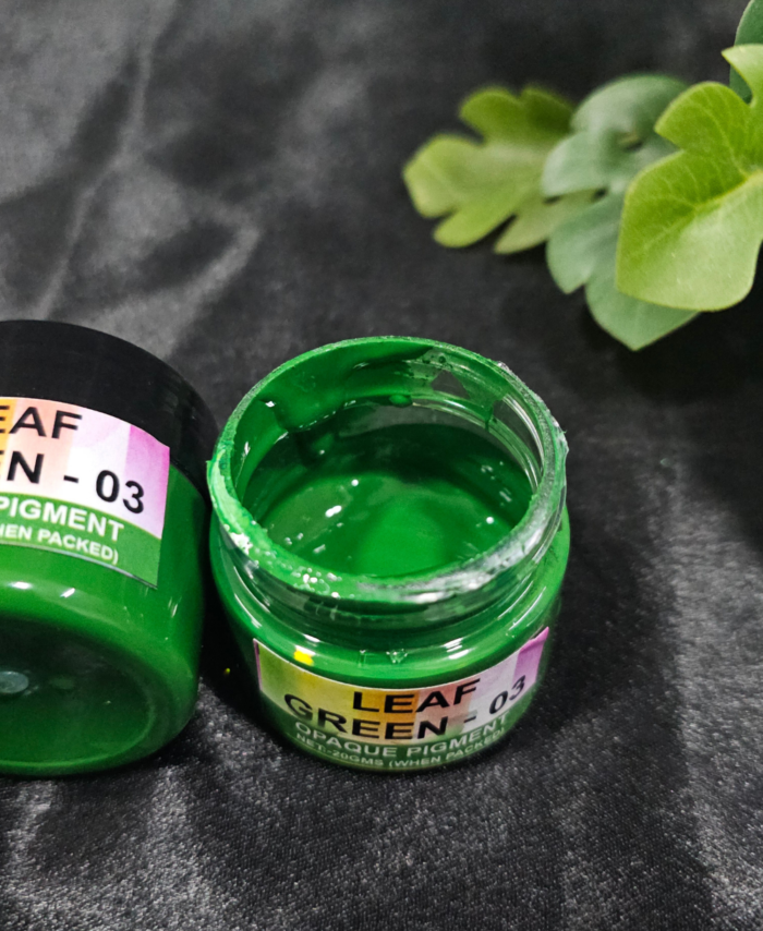 Leaf Green 03 opaque resin pigment jar opened and displayed on a black background”