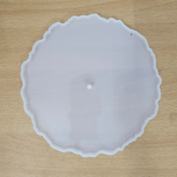"Three silicone wavy-edge cake stand moulds in different sizes placed on a wooden surface"