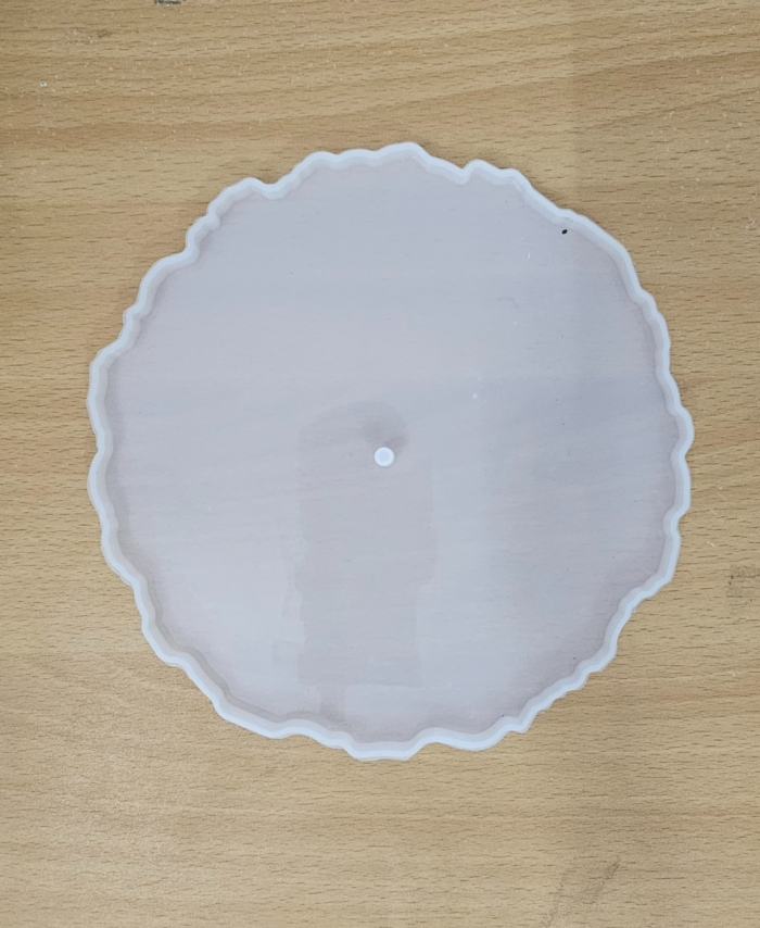 "Three silicone wavy-edge cake stand moulds in different sizes placed on a wooden surface"
