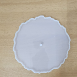 "Three silicone wavy-edge cake stand moulds in different sizes placed on a wooden surface"