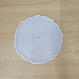 "Three silicone wavy-edge cake stand moulds in different sizes placed on a wooden surface"