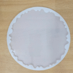 8-inch round agate silicone mould with wavy edge placed on a wooden surface