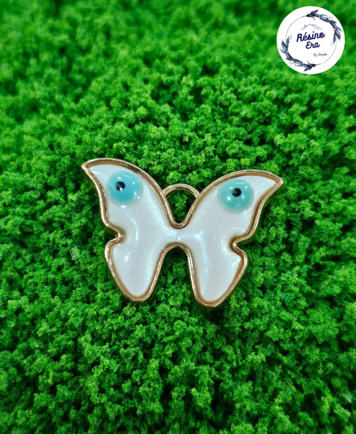 Decorative craft evil eye charms for resin art and jewellery making are displayed on a soft background