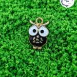 Decorative craft owl charms for resin art and jewellery making are displayed on a soft background