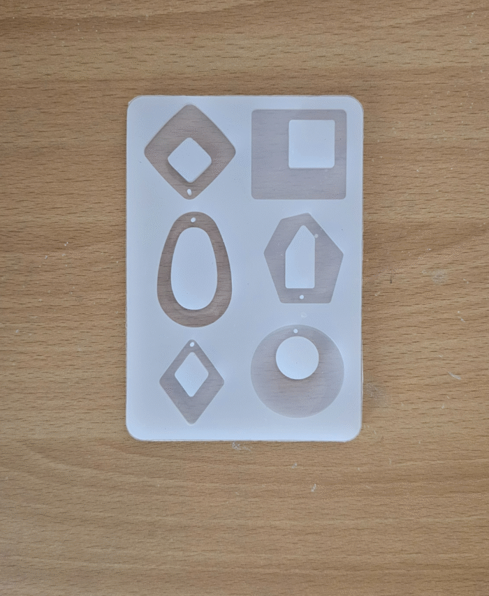 Mixed-shape silicone pendant mould sheet with several jewellery shapes, including diamond, oval, hexagon, round, and square.